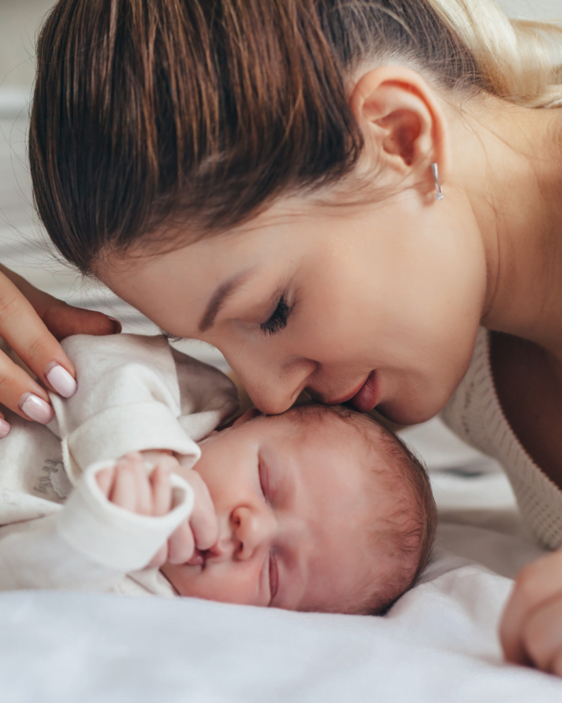 Ask for help in postpartum. Mama kissing baby on the head.