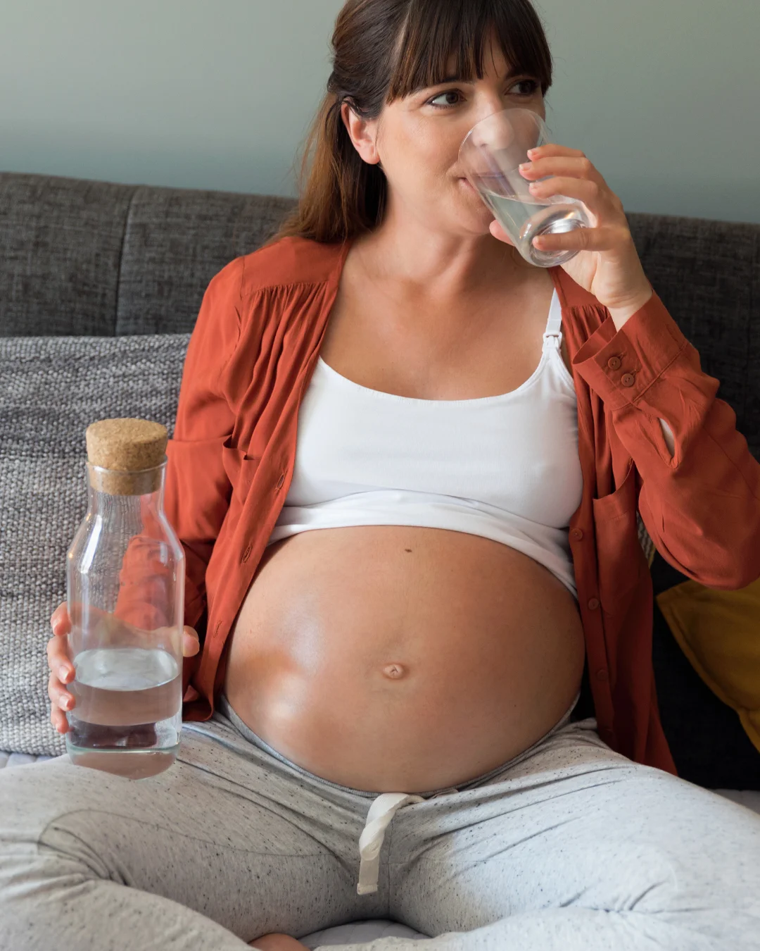Pregnant mama staying hydrated with lots of water